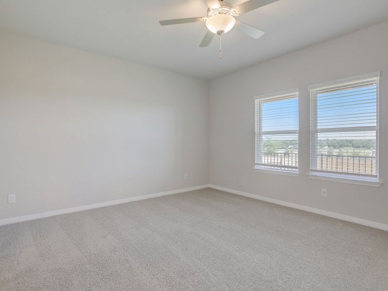 Relax in the primary bedroom and get lots of natural lighting.