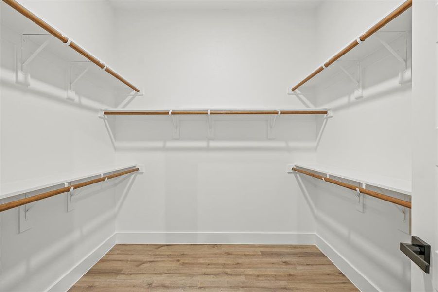 Spacious closet featuring hardwood / wood-style floors