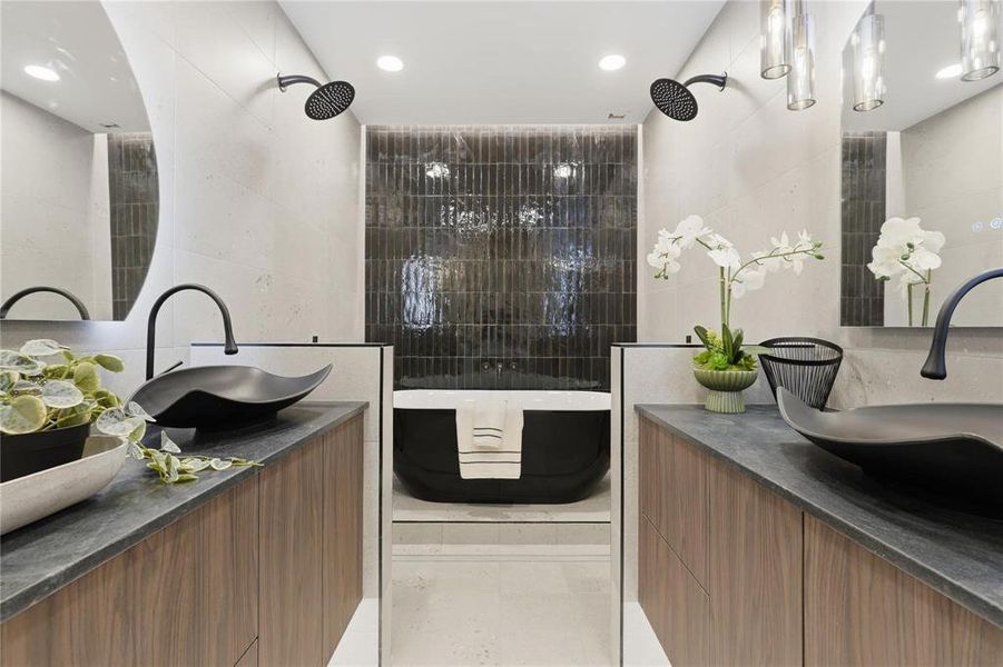 Modern bathroom featuring a freestanding soaking tub, dual shower heads, and twin wood-finish vanities with black vessel sinks