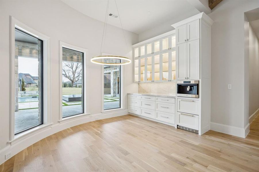 Built-in coffee maker and two drawer refrigerators underneath