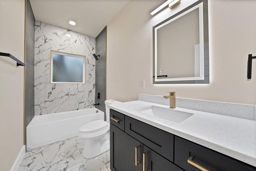 Full bath with vanity, tub / shower combination, light marble finish floors, and recessed lighting