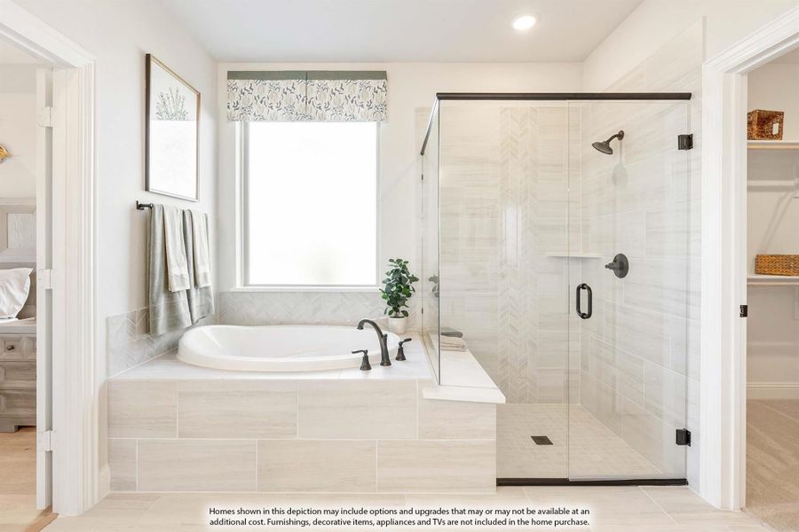 Master bathroom with soaking tub, glass walk-in shower, and chevron tile walls in neutral tones