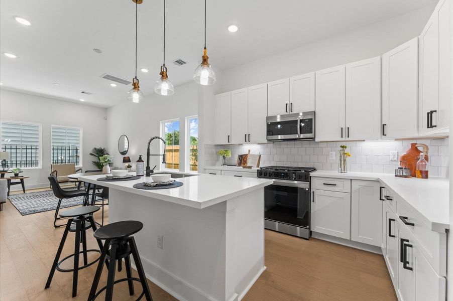 At the heart of this open-concept kitchen lies a stunning oversized island, offering generous prep space, sleek quartz countertops, and seating area. Whether you're hosting a dinner party or enjoying a casual breakfast, this island is the perfect gathering spot. Pendant lighting adds a touch of elegance, while built-in storage and a deep sink make it as functional as it is beautiful. At the heart of this open-concept kitchen lies a stunning oversized island, offering generous prep space, sleek quartz countertops, and seating area. Whether you're hosting a dinner party or enjoying a casual breakfast, this island is the perfect gathering spot. Pendant lighting adds a touch of elegance, while built-in storage and a deep sink make it as functional as it is beautiful.