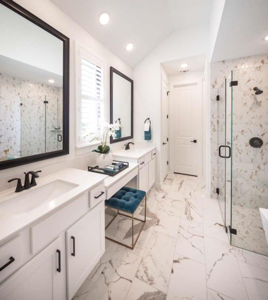 Full bathroom with vanity, vaulted ceiling, marble finish floor, and a marble finish shower