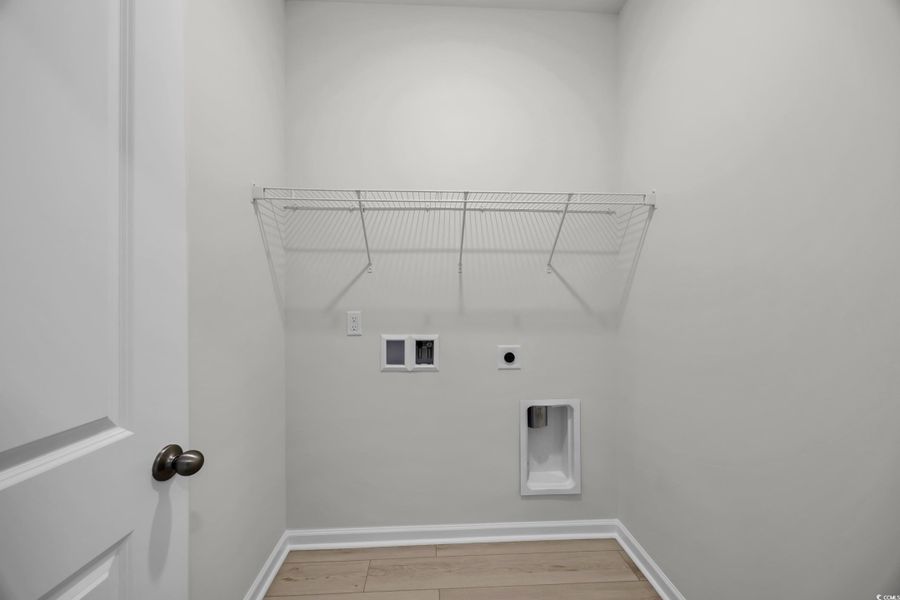Laundry area with hookup for a washing machine, electric dryer hookup, and light wood-type flooring Laundry area with hookup for a washing machine, electric dryer hookup, and light wood-type flooring