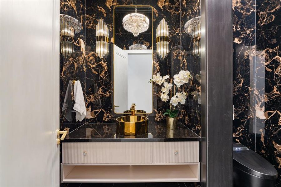 Escape to a hotel-inspired powder room that exudes luxury and sophistication, making everyday tasks feel like a pampering experience.