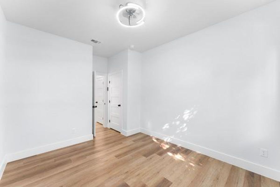 Unfurnished room featuring baseboards and light wood finished floors Unfurnished room featuring baseboards and light wood finished floors