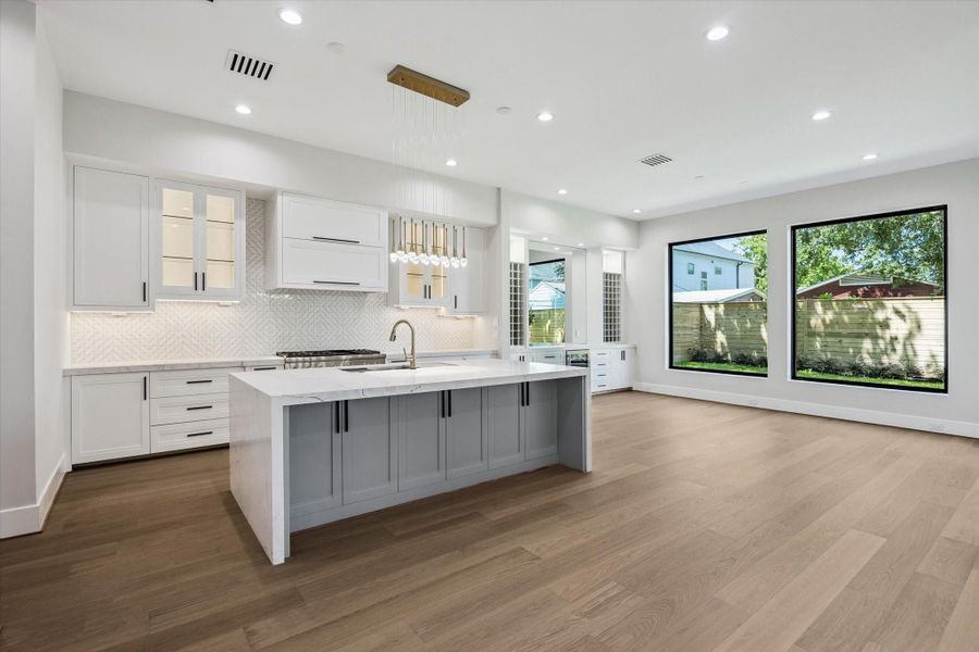 The heart of the home lies in the chef's dream kitchen boasting Thermador appliances, including a professional-grade gas range, all centered around a massive island that invites culinary creativity and socializing. The heart of the home lies in the chef's dream kitchen boasting Thermador appliances, including a professional-grade gas range, all centered around a massive island that invites culinary creativity and socializing.