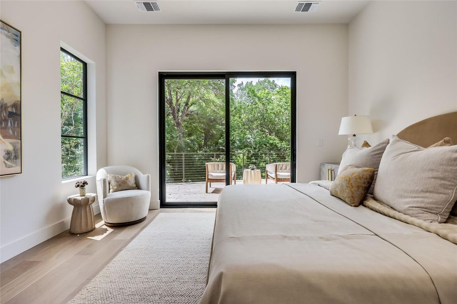 Spacious room with light wood-finish flooring and a private outdoor balcony