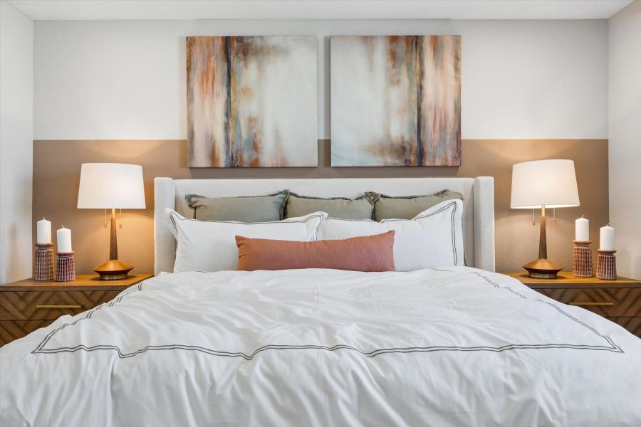 A bed with white sheets.