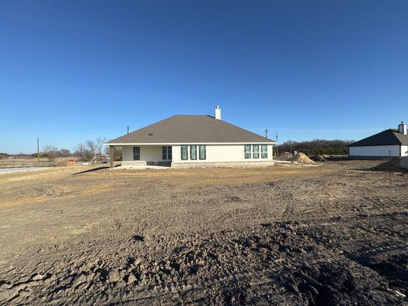 Back of house with a patio area and a chimney