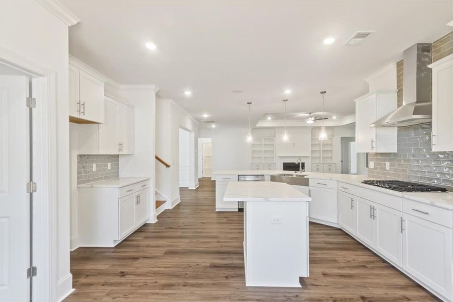 Crisp white cabinetry paired with durable wood flo