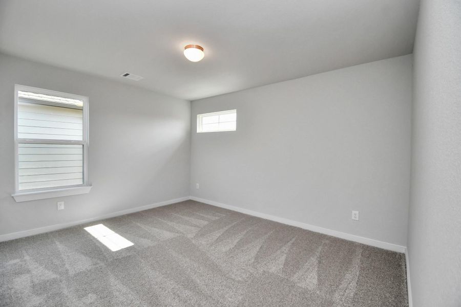 Secondary bedroom features plush carpeting, large windows that let in plenty of natural light, bright paint, and spacious closets. Secondary bedroom features plush carpeting, large windows that let in plenty of natural light, bright paint, and spacious closets.