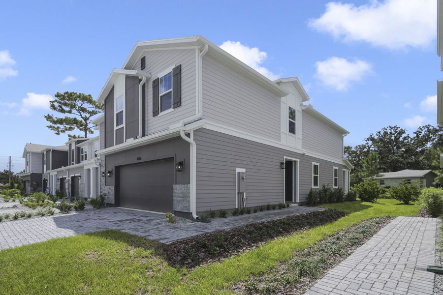 Front exterior of a new home in Towns at Greenleaf, Oviedo, FL, highlighting curb appeal (Image 2).