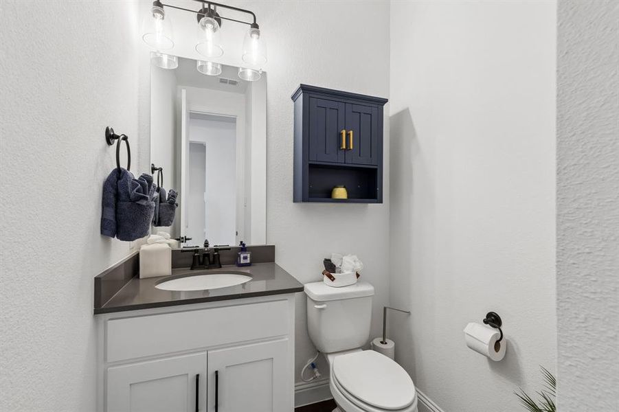 Half Bath
Conveniently located for guests, the powder bath features contemporary finishes and a clean, polished design.