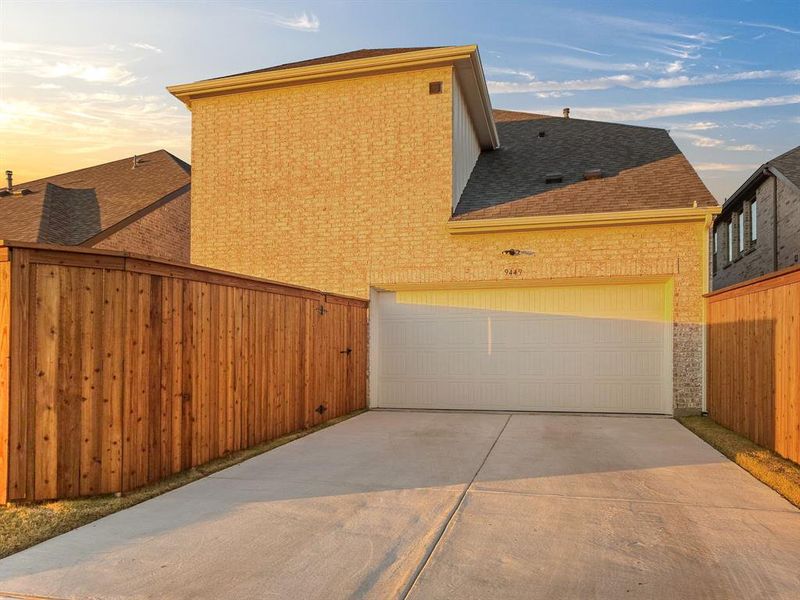 Property exterior at dusk featuring a garage