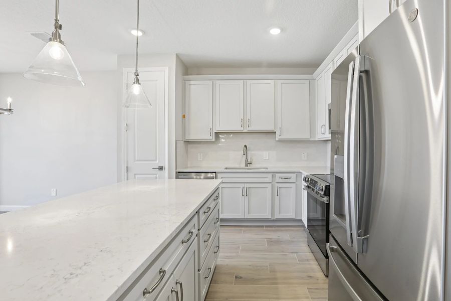 Foyer leads into generous kitchen featuring AW Collection® Milan