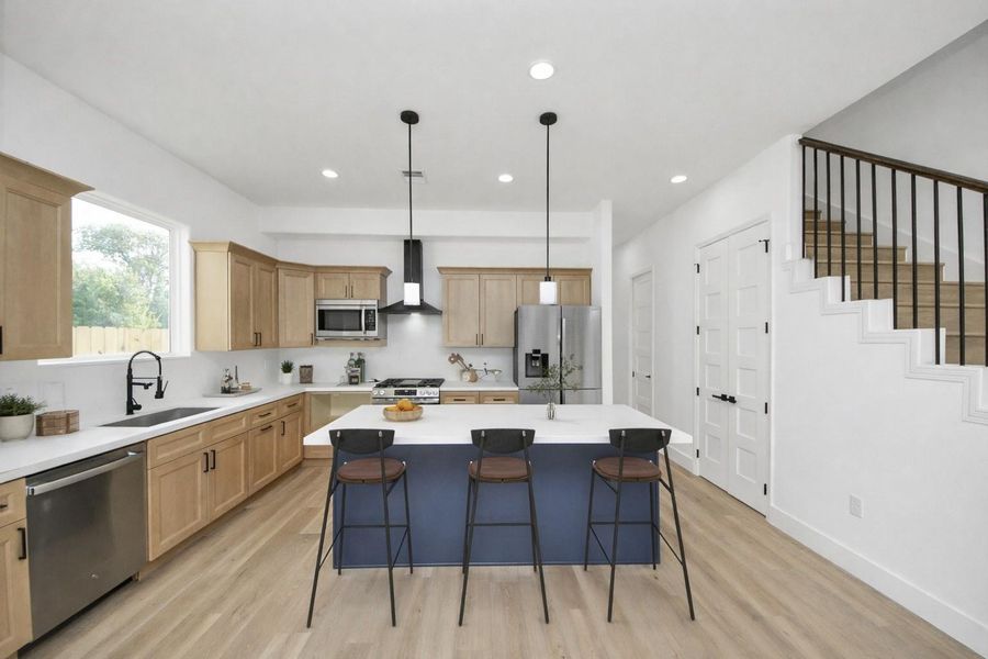 Bright, open-concept layout with a spacious island, modern finishes, and great natural light—perfect for everyday living and entertaining.