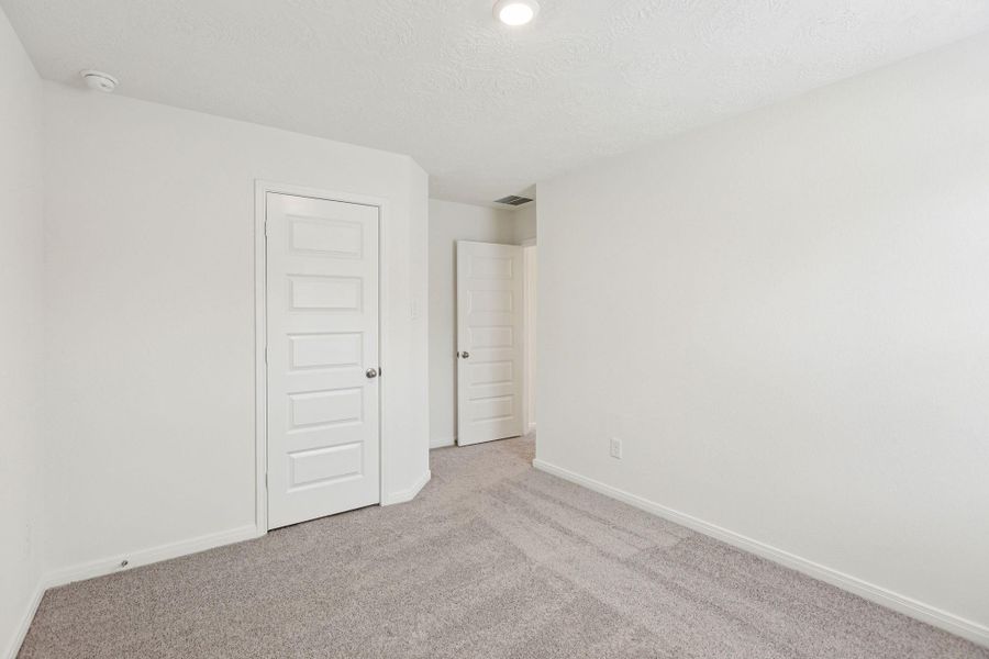 View of closet door and entrance to this secondary bedroom.