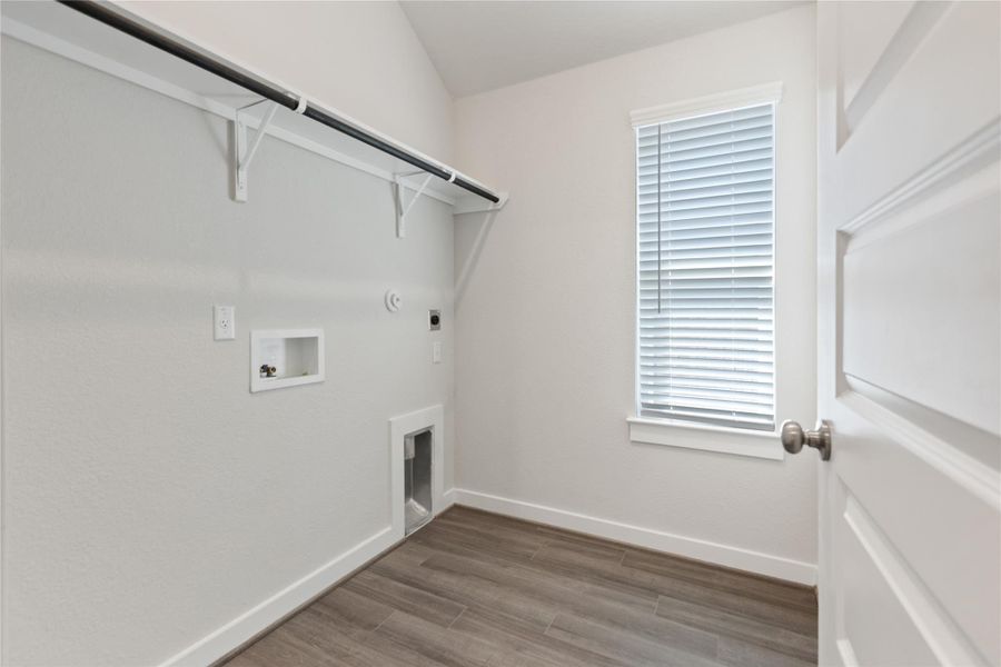 Laundry room with dark wood finished floors, hookup for a washing machine, gas dryer hookup, and hookup for an electric dryer