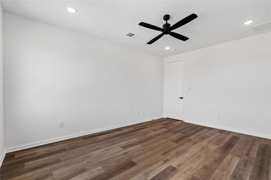 primary bedroom designed as a restful retreat, with ample space for furnishings and natural light throughout