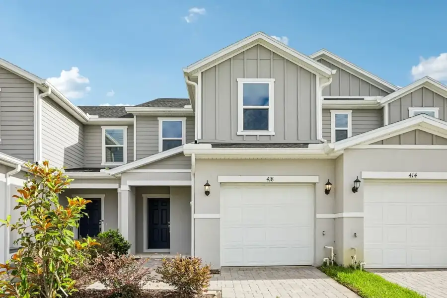 Front exterior of a new home in Reserve at Forest Lake Townhomes, Lake Wales, FL, highlighting curb appeal (Image 1). Front exterior of a new home in Reserve at Forest Lake Townhomes, Lake Wales, FL, highlighting curb appeal (Image 1).