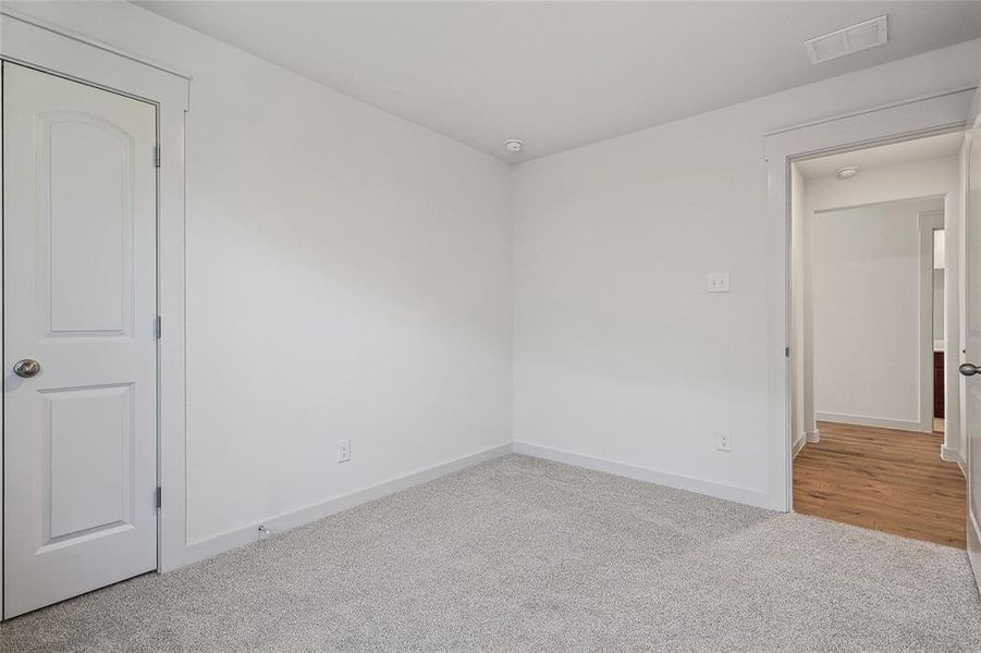 Unfurnished room featuring light carpet