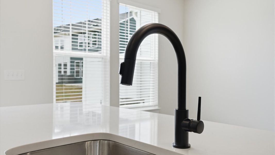 Elegant kitchen with large island and stylish hardware in this first-class DRB Homes design Elegant kitchen with large island and stylish hardware in this first-class DRB Homes design