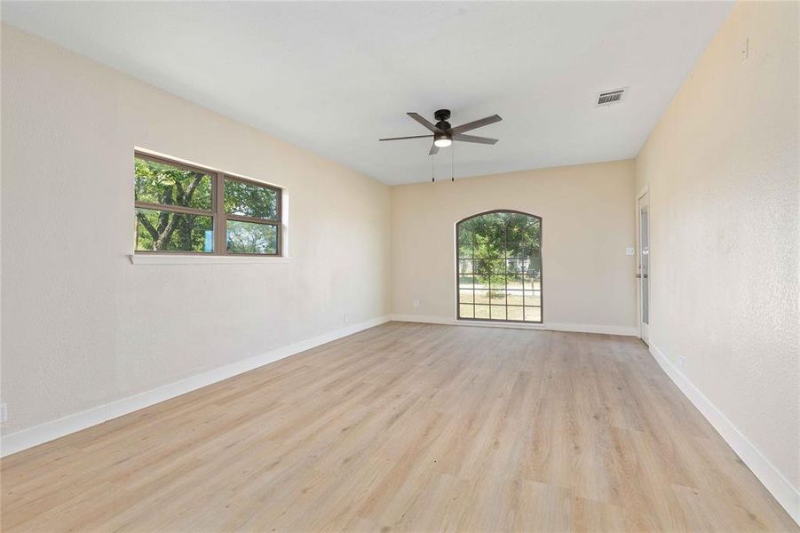 Spare room with light wood-style flooring and a ceiling fan Spare room with light wood-style flooring and a ceiling fan