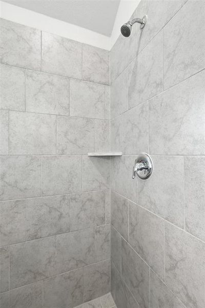 Full bath with tiled shower