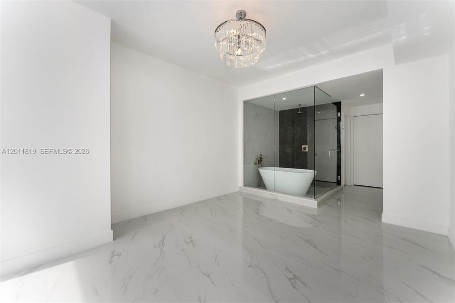 Serene primary suite offering unobstructed water views, direct terrace access, oversized walk-in closets, and floor-to-ceiling windows for a true 'mansion in the sky' feel.