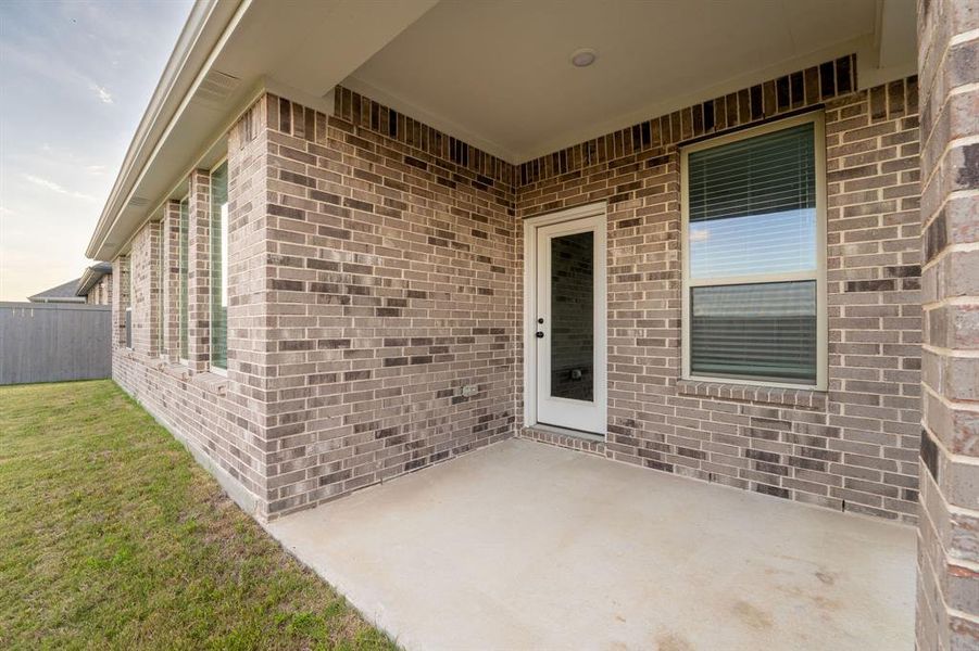 Exterior details and patio area of a home in Prairie Ridge at Goodland, Midlothian (Image 3).
