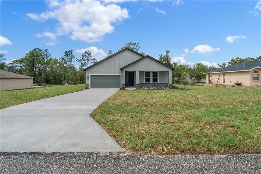 Front exterior of a new home in , Weeki Wachee, FL, highlighting curb appeal (Image 29). Front exterior of a new home in , Weeki Wachee, FL, highlighting curb appeal (Image 29).