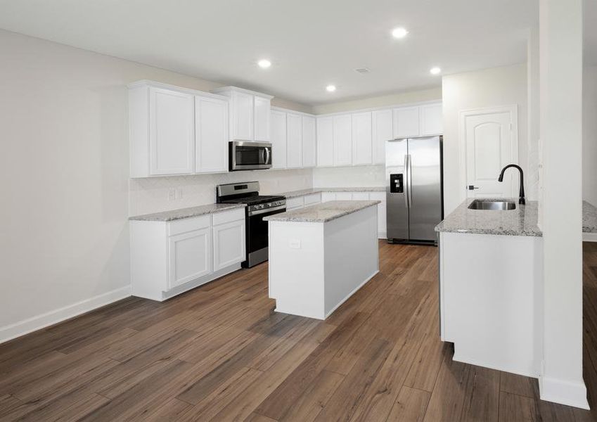 Kitchen with white cabinets and stainless appliances