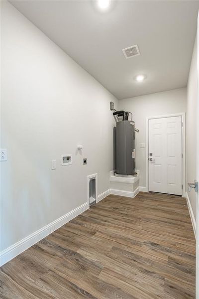 Laundry room featuring washer hookup, electric dryer hookup, wood-type flooring, and water heater