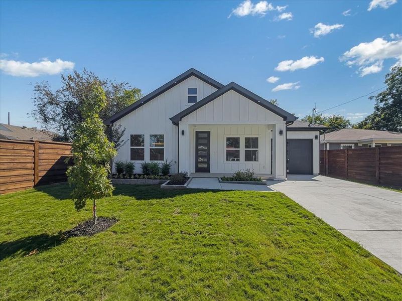 Modern farmhouse featuring board and batten siding, driveway, and a garage Modern farmhouse featuring board and batten siding, driveway, and a garage