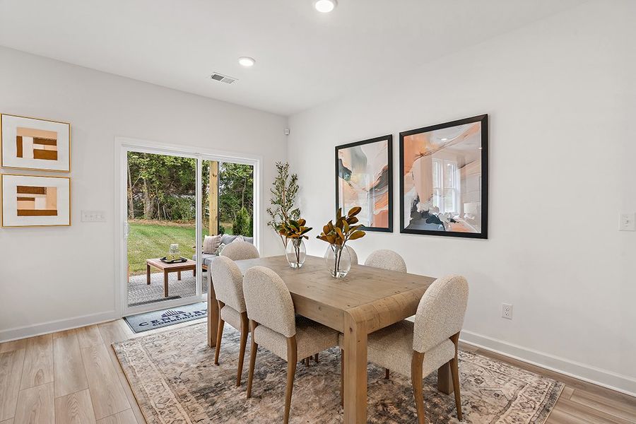 A dining room with a table and chairs. A dining room with a table and chairs.