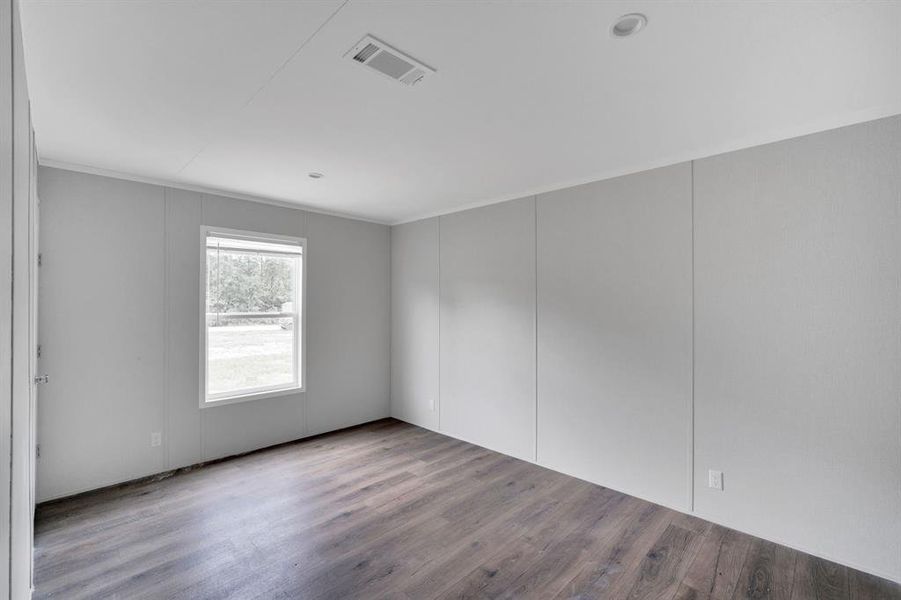 Interior room featuring wood-finish flooring and light gray walls