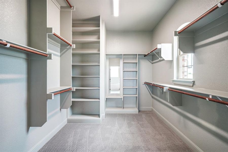 Custom primary closet with 10ft ceilings and built in mirror.