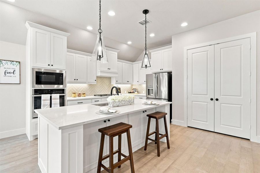 Culinary excellence awaits in this well-appointed kitchen, featuring a central island and contemporary fixtures.