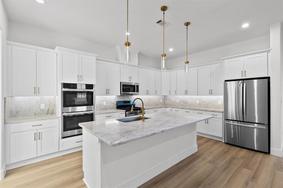 Stunning, modern kitchen with every convenience! Large island with space for barstools, double oven, soft close doors, under cabinet lighting, and refrigerator INCLUDED!!!
