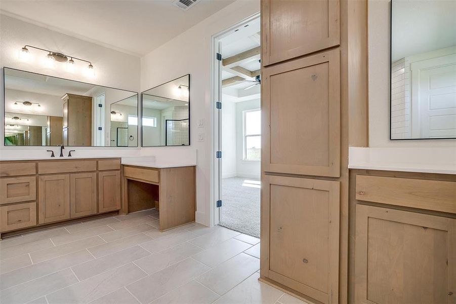 Bathroom featuring beam ceiling, vanity, and tile patterned floors