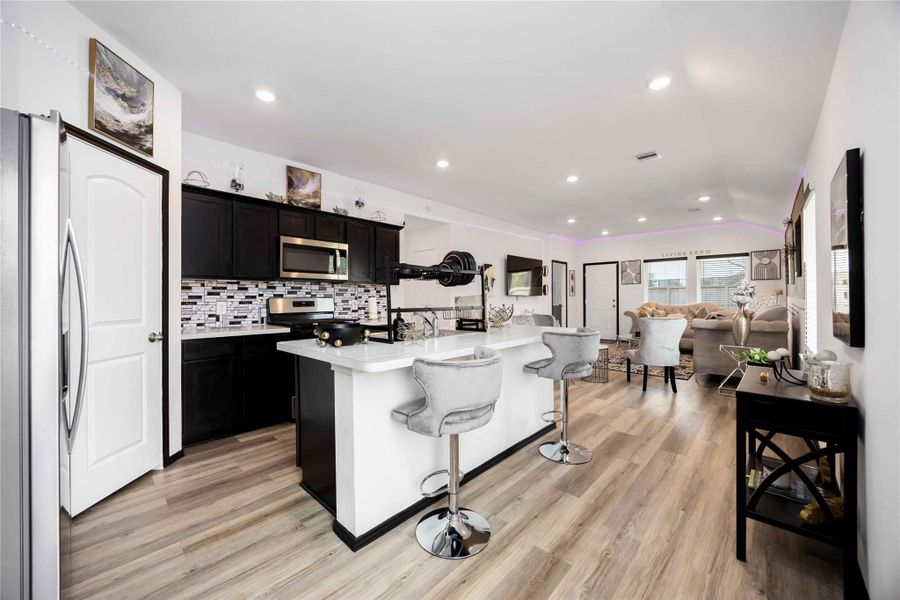 This photo showcases a modern open-concept kitchen and living area.