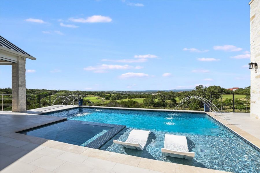 View of swimming pool featuring a pool with connected hot tub and a patio area View of swimming pool featuring a pool with connected hot tub and a patio area