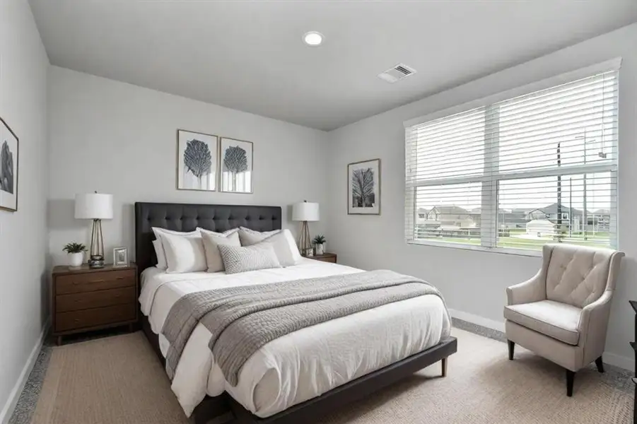 Secondary bedroom. Plush carpet, neutral paint color, large windows, and spacious closets.