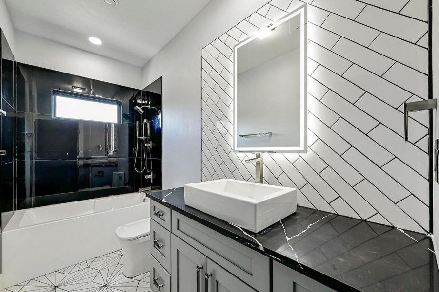 This full secondary bathroom is located upstairs and comes with designer finishes and a shower/tub combo with gorgeous tile backsplash. This full secondary bathroom is located upstairs and comes with designer finishes and a shower/tub combo with gorgeous tile backsplash.