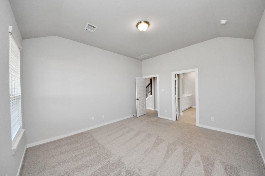 Come and unwind after a long day in this magnificent primary suite! This spacious room features plush carpet, warm paint, high ceilings and large windows with privacy blinds. Sample photo of completed home with similar floor plan. Actual colors and selections may vary. Come and unwind after a long day in this magnificent primary suite! This spacious room features plush carpet, warm paint, high ceilings and large windows with privacy blinds. Sample photo of completed home with similar floor plan. Actual colors and selections may vary.