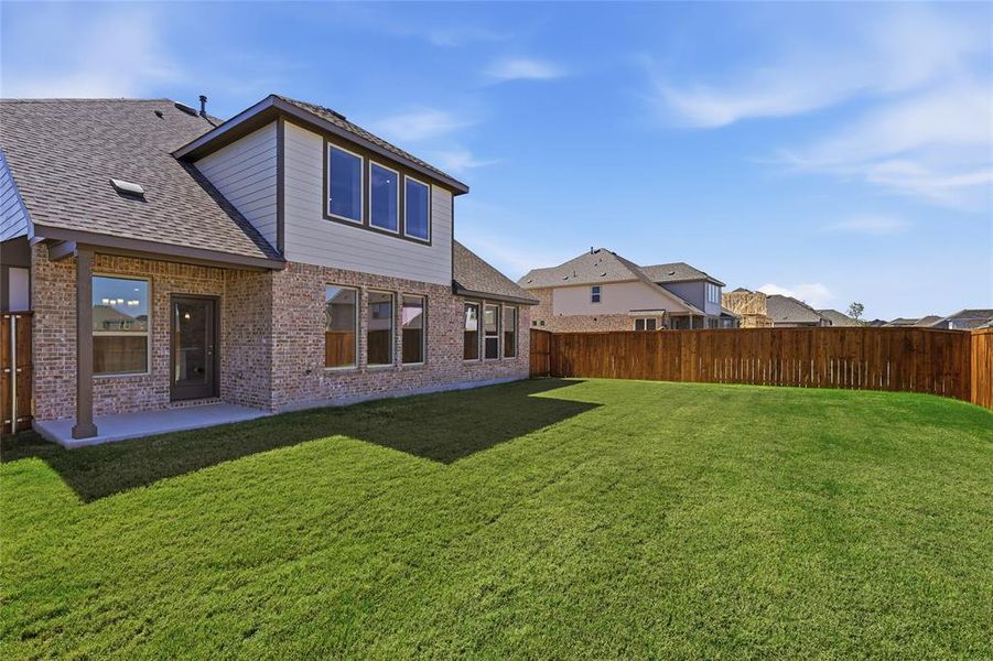 Expansive green lawn with a newly installed wood privacy fence