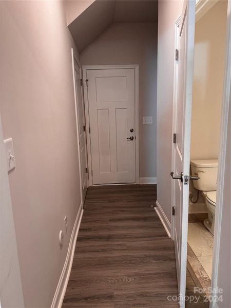 Hall leading to garage, drop zone, closet and half bath