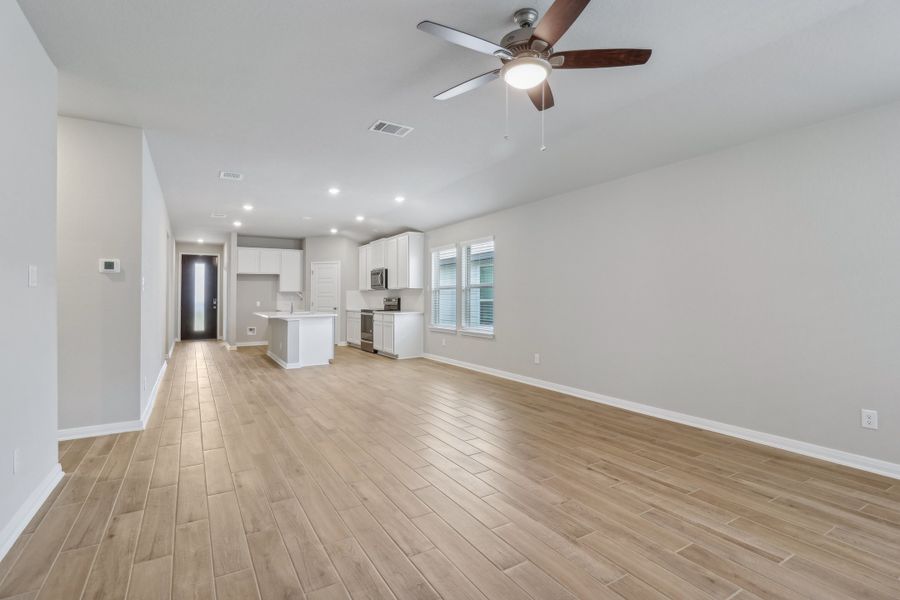Dining room, living room, and kitchen in the Allen floorplan at a Meritage Homes community. Dining room, living room, and kitchen in the Allen floorplan at a Meritage Homes community.